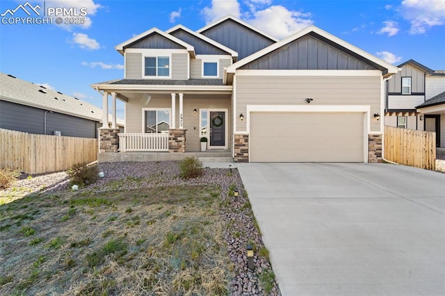 2972 Namib Dr, Colorado Springs, CO 80939 - craftsman-style home featuring a porch, board and batten siding, fence, and stone siding