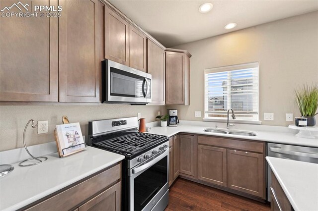 2972 Namib Dr, Colorado Springs, CO 80939 - kitchen featuring dark wood finished floors, a sink, light countertops, stainless steel appliances, and recessed lighting