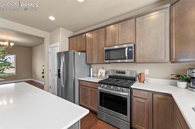 2972 Namib Dr, Colorado Springs, CO 80939 - kitchen with appliances with stainless steel finishes, light countertops, a notable chandelier, recessed lighting, and dark wood-type flooring
