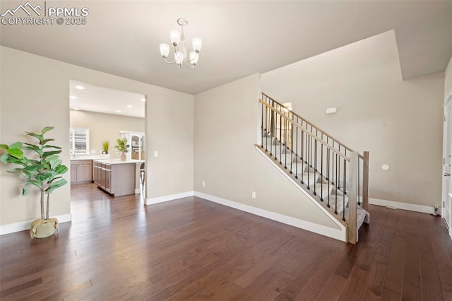 2972 Namib Dr, Colorado Springs, CO 80939 - living area with baseboards, a chandelier, dark wood-style floors, and stairway