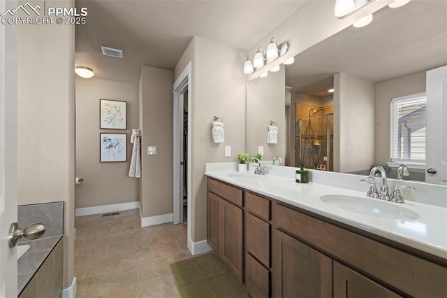 2972 Namib Dr, Colorado Springs, CO 80939 - full bath with baseboards, visible vents, a sink, and a stall shower