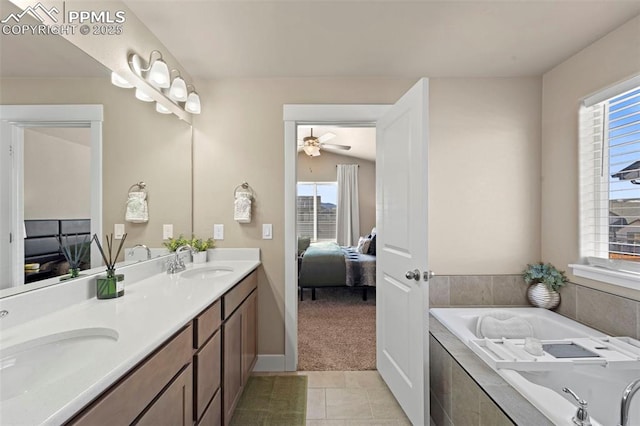 2972 Namib Dr, Colorado Springs, CO 80939 - bathroom with ensuite bathroom, a sink, a bath, and tile patterned flooring