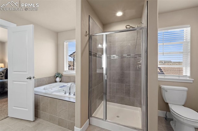 2972 Namib Dr, Colorado Springs, CO 80939 - bathroom with tile patterned flooring, toilet, baseboards, a shower stall, and a garden tub