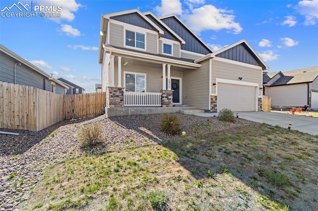 2972 Namib Dr, Colorado Springs, CO 80939 - craftsman house featuring fence, stone siding, board and batten siding, a porch, and driveway