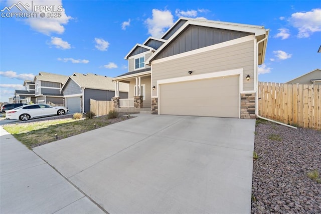 2972 Namib Dr, Colorado Springs, CO 80939 - craftsman-style home featuring board and batten siding, fence, driveway, and stone siding