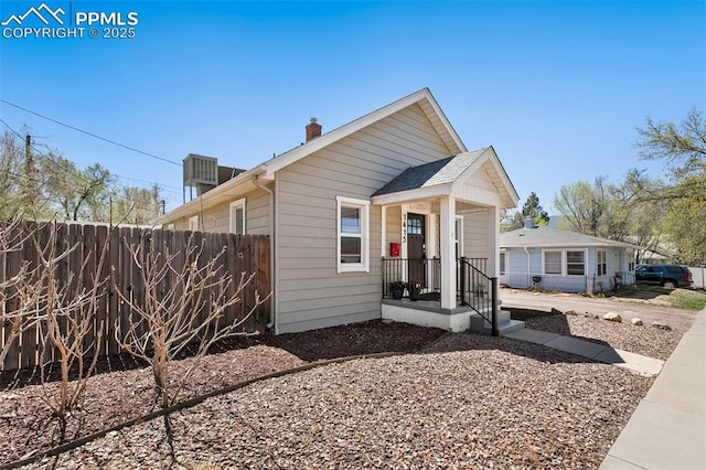 1415 E Boulder St, Colorado Springs, CO 80909 - bungalow-style house with fence and a chimney