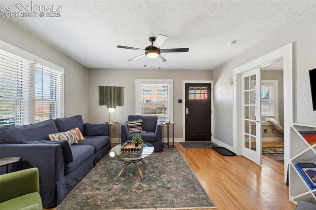 1415 E Boulder St, Colorado Springs, CO 80909 - living room with french doors, a ceiling fan, light wood-style flooring, and a textured ceiling