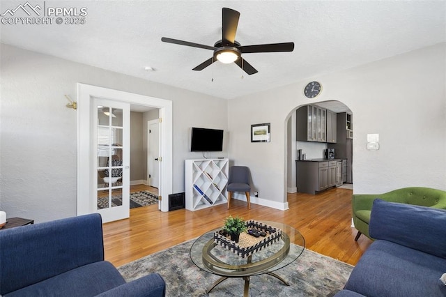 1415 E Boulder St, Colorado Springs, CO 80909 - living area featuring light wood-style floors, arched walkways, and a ceiling fan