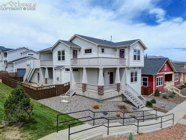 275 Eclipse Dr, Colorado Springs, CO 80905 - back of house with a balcony, fence, covered porch, and a residential view