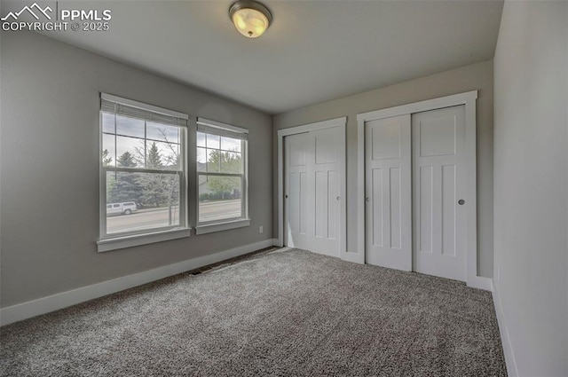275 Eclipse Dr, Colorado Springs, CO 80905 - unfurnished bedroom featuring multiple closets, carpet flooring, and baseboards