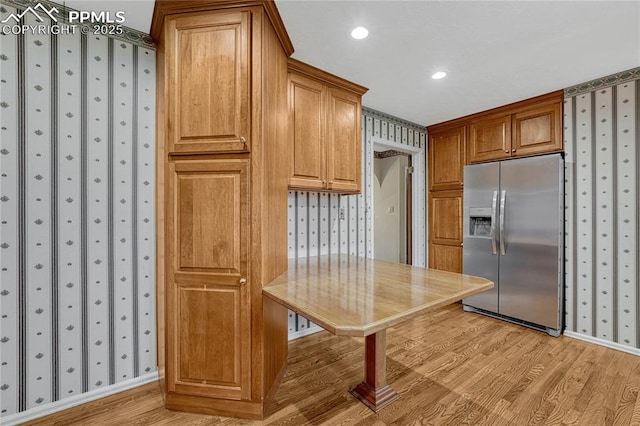 10 Gold Coin Ct, Colorado Springs, CO 80919 - kitchen featuring stainless steel fridge with ice dispenser, brown cabinets, light wood-type flooring, and wallpapered walls