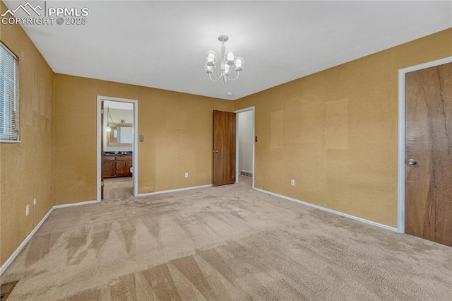 10 Gold Coin Ct, Colorado Springs, CO 80919 - unfurnished bedroom with an inviting chandelier, baseboards, carpet floors, and ensuite bathroom