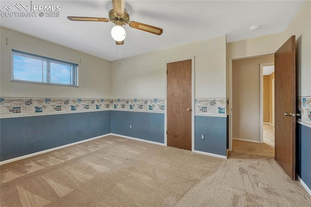 10 Gold Coin Ct, Colorado Springs, CO 80919 - carpeted empty room with wainscoting, baseboards, and a ceiling fan
