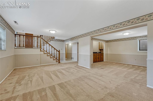10 Gold Coin Ct, Colorado Springs, CO 80919 - below grade area featuring stairway, a wainscoted wall, carpet, and visible vents