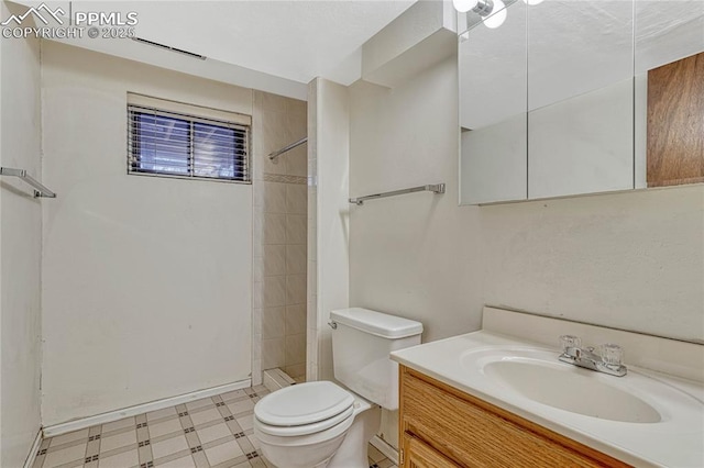 10 Gold Coin Ct, Colorado Springs, CO 80919 - bathroom featuring tile patterned floors, vanity, toilet, and tiled shower