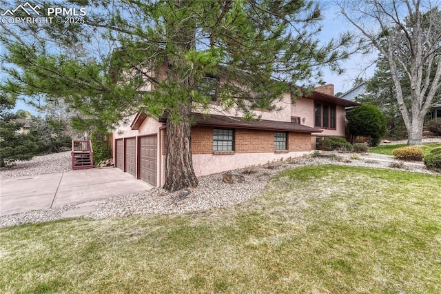 10 Gold Coin Ct, Colorado Springs, CO 80919 - view of side of property featuring a lawn, brick siding, driveway, and stucco siding