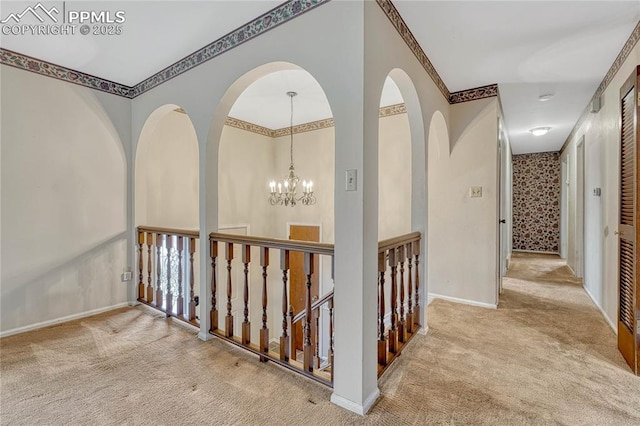 10 Gold Coin Ct, Colorado Springs, CO 80919 - hallway featuring crown molding, carpet flooring, baseboards, and a chandelier