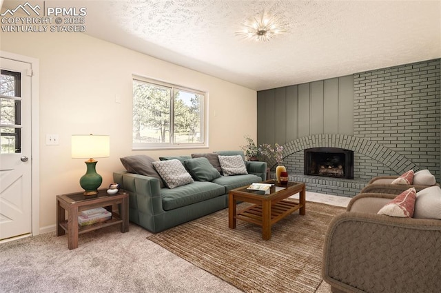 carpeted living room with a textured ceiling, a healthy amount of sunlight, and a fireplace