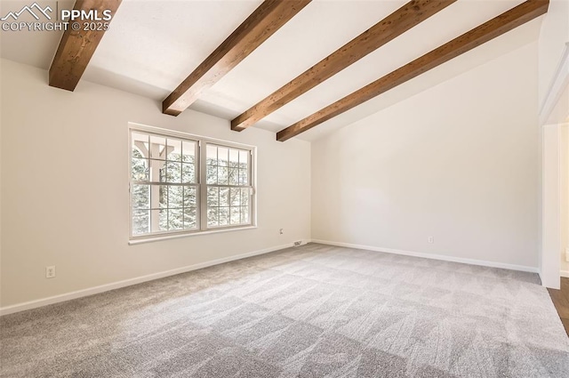 carpeted empty room with baseboards and lofted ceiling with beams