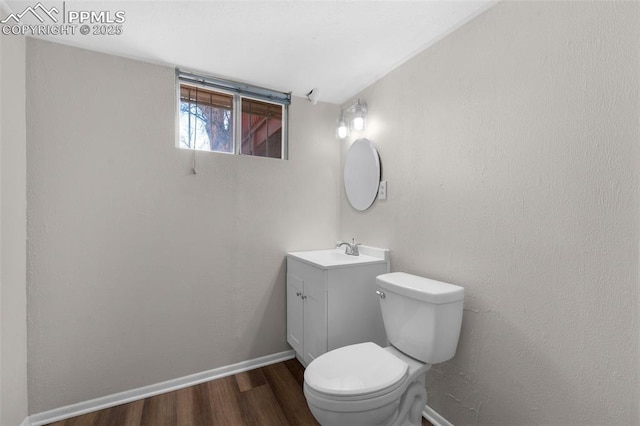 3435 Montebello Dr, Colorado Springs, CO 80918 - half bath featuring baseboards, vanity, toilet, and wood finished floors