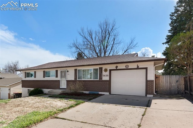 3435 Montebello Dr, Colorado Springs, CO 80918 - ranch-style home with brick siding, a garage, fence, and concrete driveway