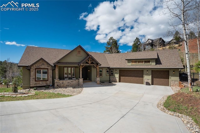 view of front facade with a garage, a porch, driveway, and stone siding