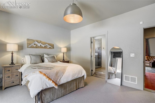 bedroom featuring arched walkways, baseboards, visible vents, and ensuite bathroom