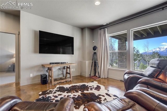 living area featuring baseboards, recessed lighting, and wood finished floors
