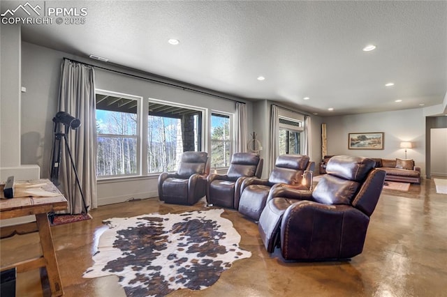 cinema with recessed lighting, a textured ceiling, baseboards, and finished concrete floors