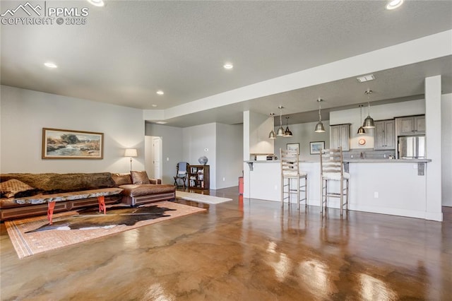 living area with recessed lighting and concrete floors