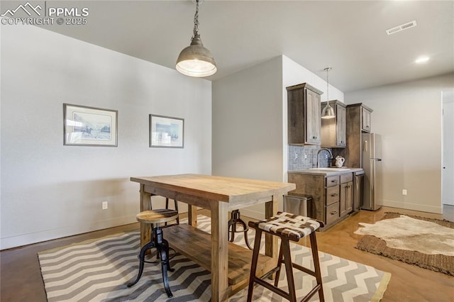 dining space featuring baseboards and visible vents