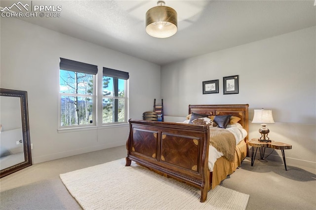 bedroom with baseboards and carpet
