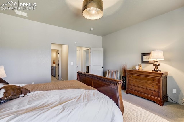 bedroom featuring light colored carpet and connected bathroom