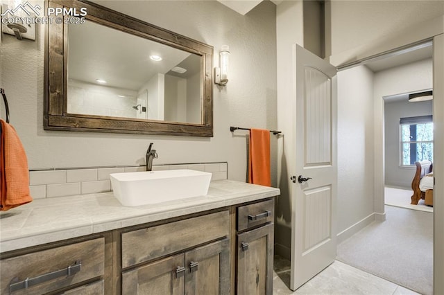 bathroom featuring vanity and tasteful backsplash
