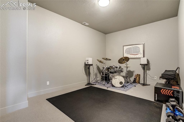 exercise room with baseboards, carpet, and visible vents