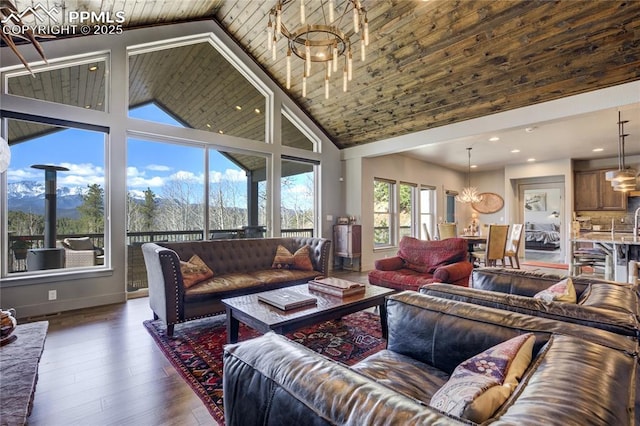 living area with wood-type flooring, recessed lighting, high vaulted ceiling, and a notable chandelier