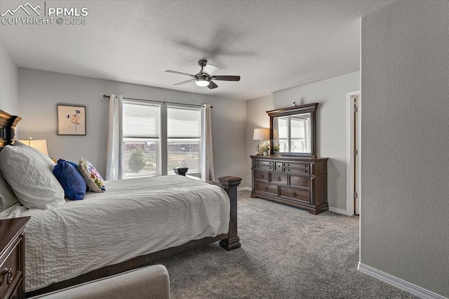 carpeted bedroom with baseboards, ceiling fan, and a textured ceiling