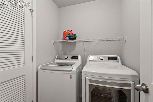 clothes washing area with washing machine and clothes dryer and laundry area