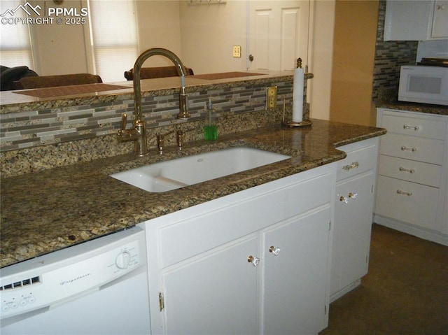 415 Veta Ave, Pueblo, CO 81004 - kitchen with white cabinets, a sink, white appliances, dark stone countertops, and backsplash