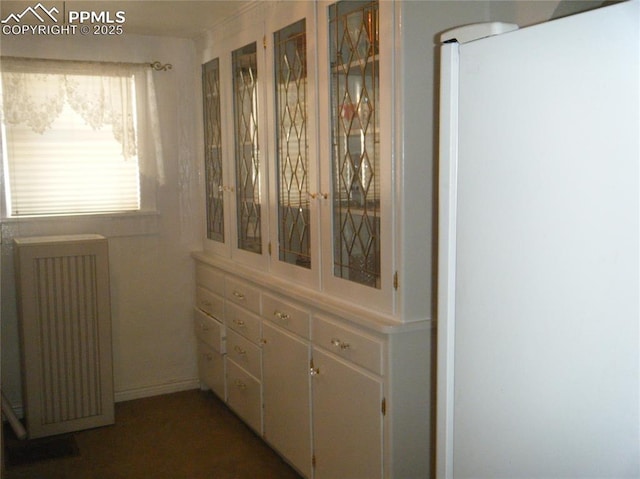 415 Veta Ave, Pueblo, CO 81004 - room details featuring freestanding refrigerator and radiator heating unit