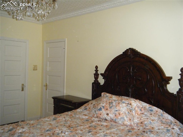 415 Veta Ave, Pueblo, CO 81004 - bedroom with crown molding and an inviting chandelier