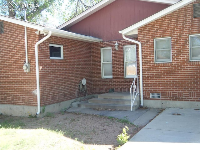 415 Veta Ave, Pueblo, CO 81004 - property entrance with brick siding and crawl space