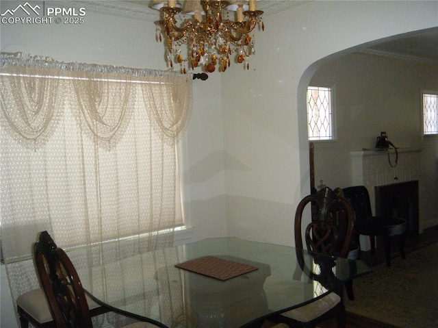 415 Veta Ave, Pueblo, CO 81004 - dining space featuring arched walkways, an inviting chandelier, and ornamental molding