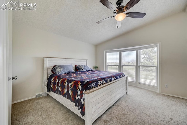 bedroom with ceiling fan, a textured ceiling, carpet floors, baseboards, and lofted ceiling