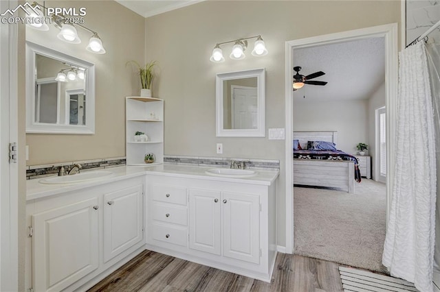 bathroom featuring double vanity, a sink, and ensuite bath