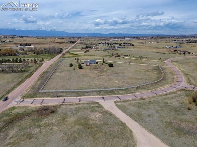 drone / aerial view featuring a rural view and a mountain view