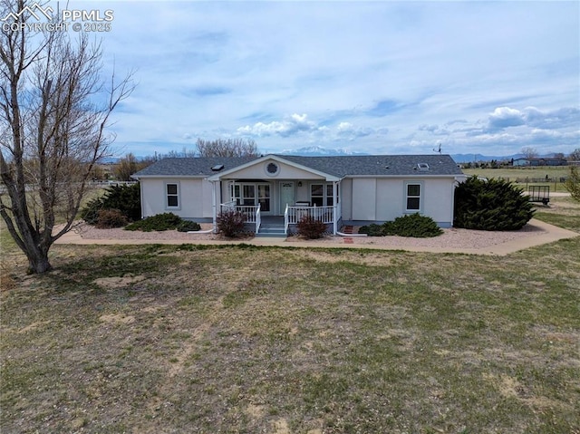 ranch-style house with covered porch, a front yard, and stucco siding