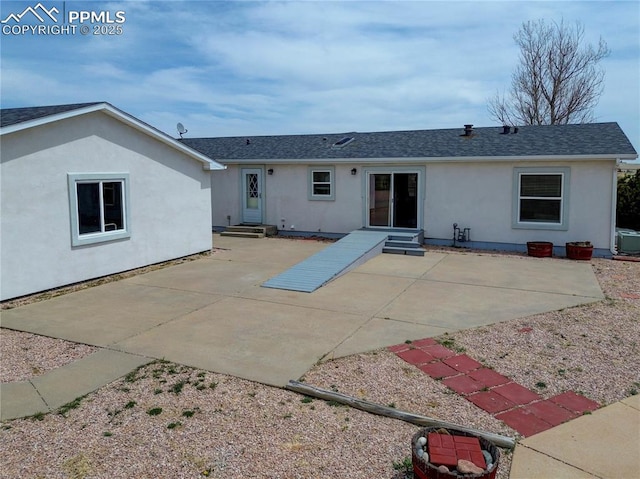 back of house with a patio area, entry steps, and stucco siding