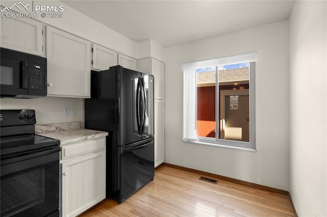 kitchen featuring visible vents, light countertops, black appliances, and a healthy amount of sunlight