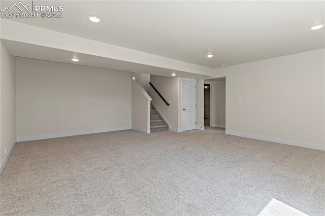 9803 Blaurock Dr, Fountain, CO 80817 - finished basement with stairway, baseboards, recessed lighting, and light colored carpet